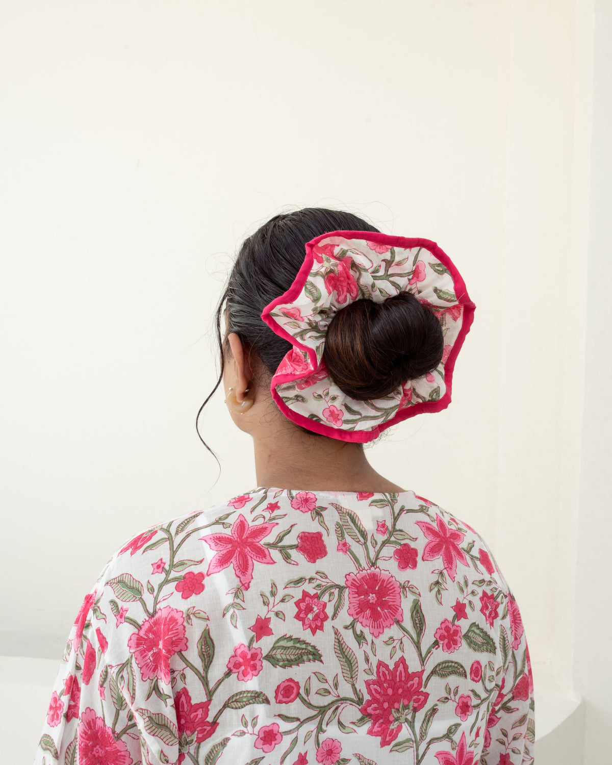 Anar Bagh Pink scrunchie closeup on model hair