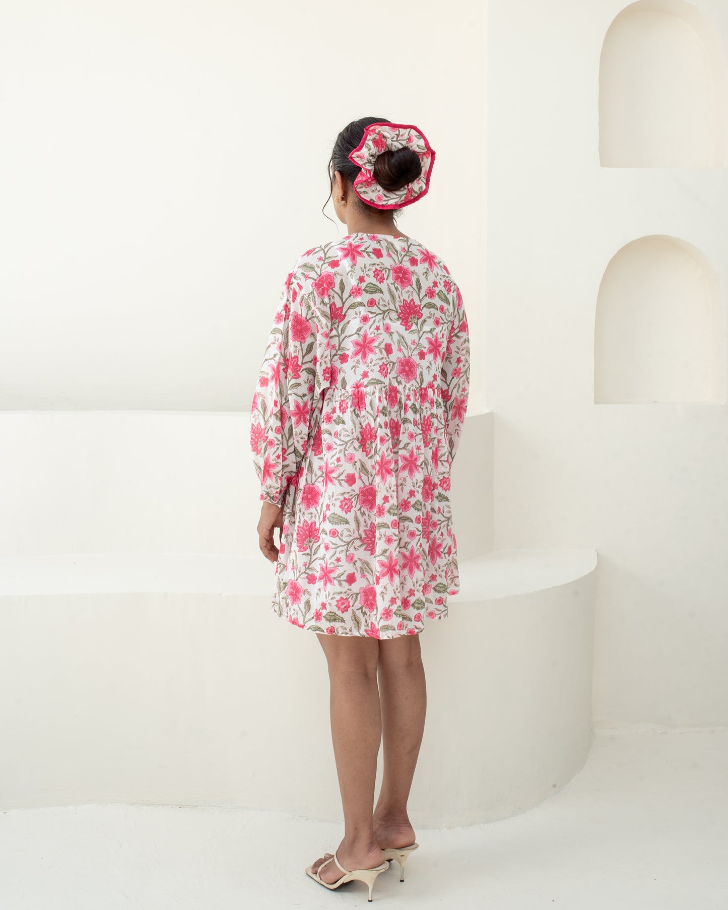 Model wearing the Anar Bagh pink floral hand block printed cotton mini dress back detail