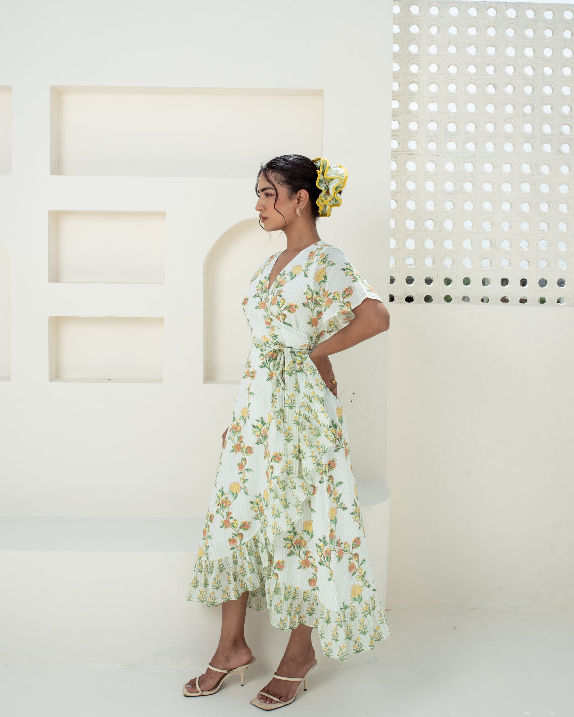Model wearing the Anar Bagh yellow floral hand block printed cotton wrap dress