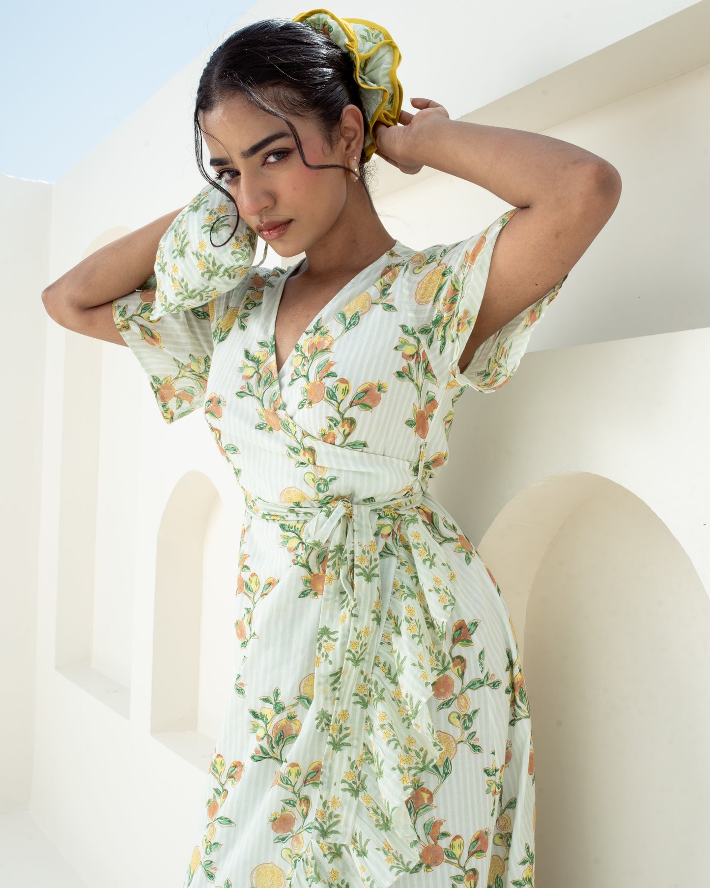 Front detail of the Anar bAGH cotton wrap dress with flutter sleeves adjustable tie detail for relaxed fit