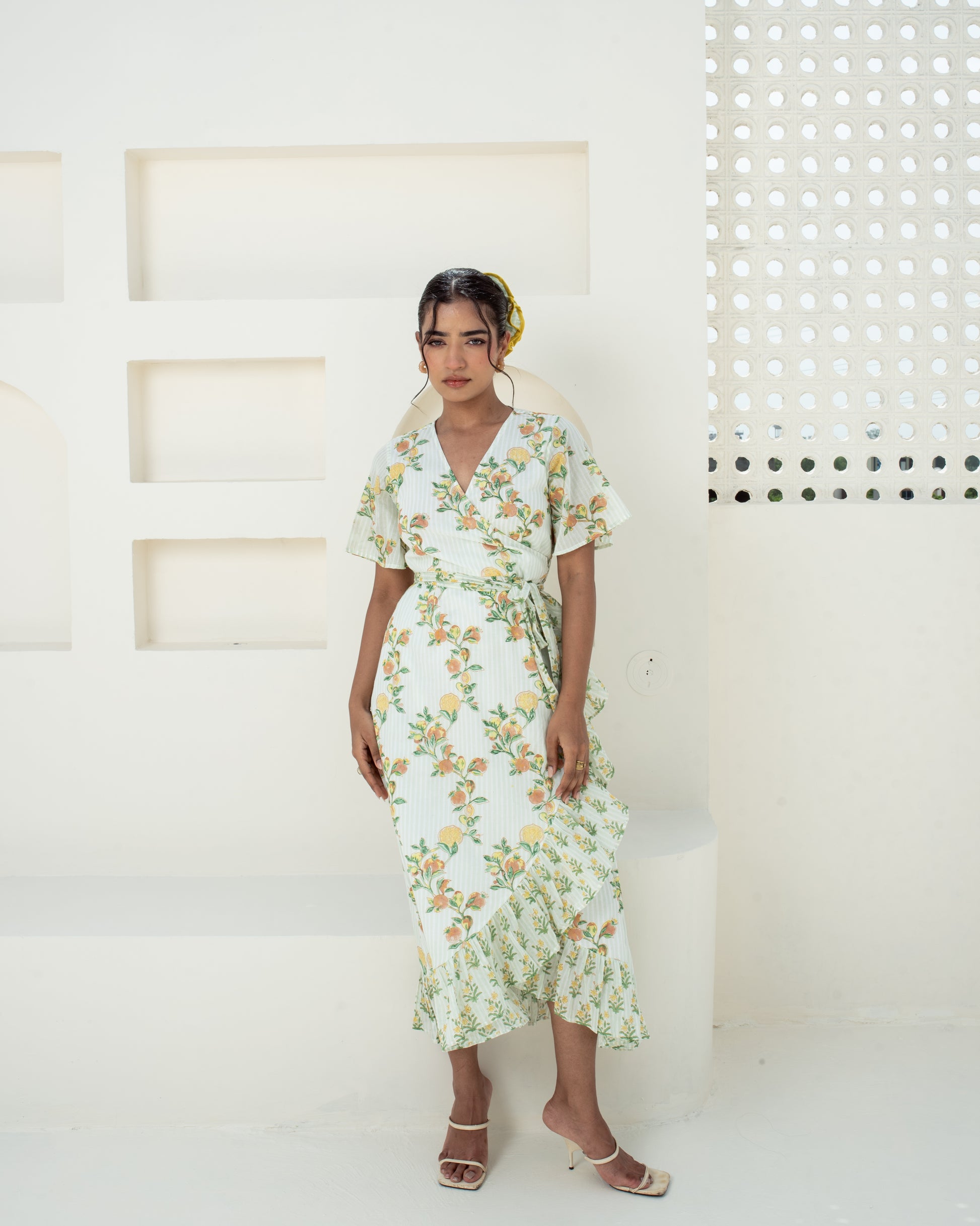 Model wearing the Anar Bagh yellow floral hand block printed cotton wrap dress