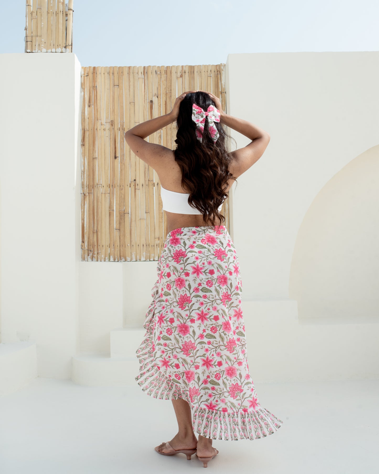 Model wearing the Anar Bagh pink floral hand block printed cotton pareo