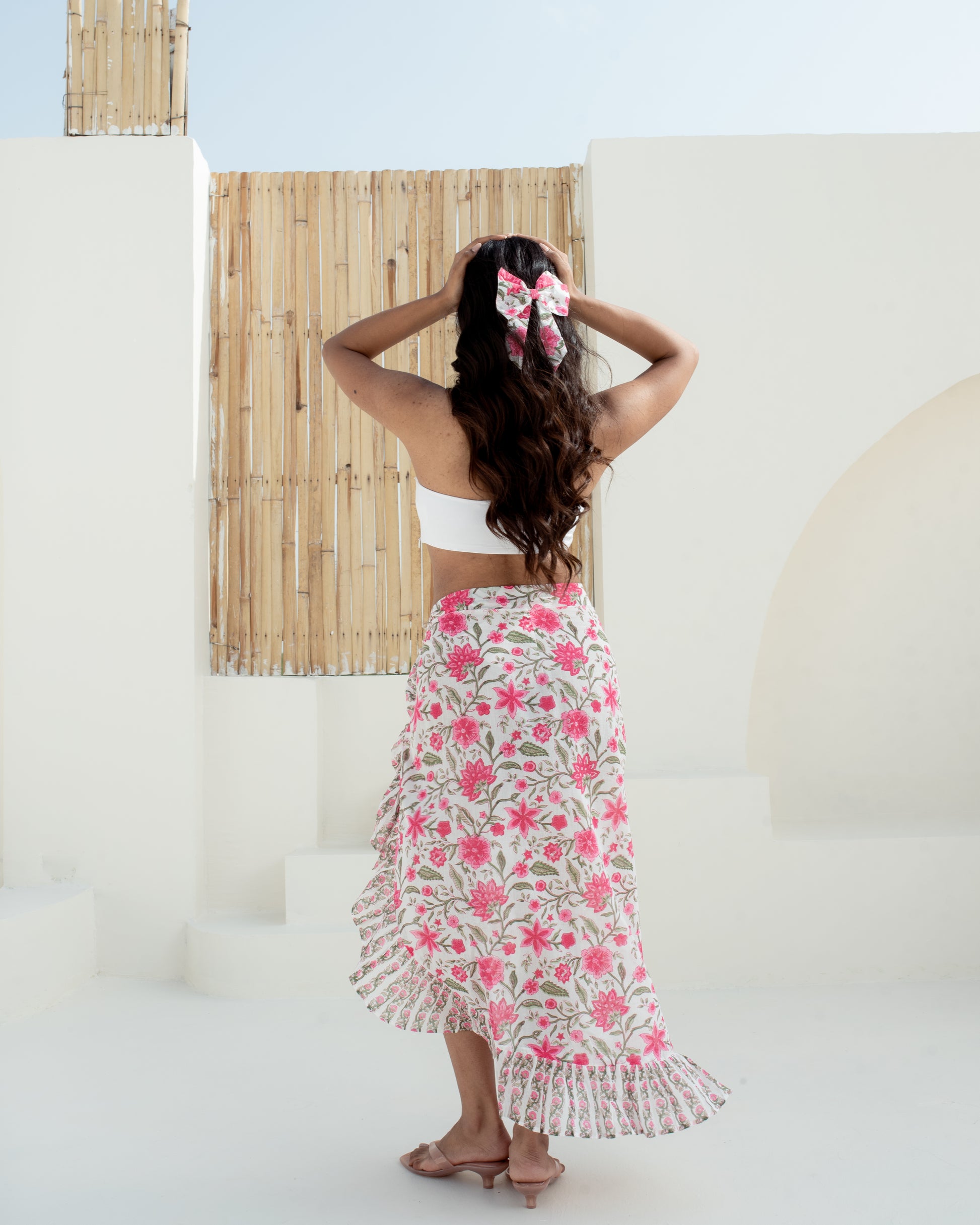 Model wearing the Anar Bagh pink floral hand block printed cotton pareo