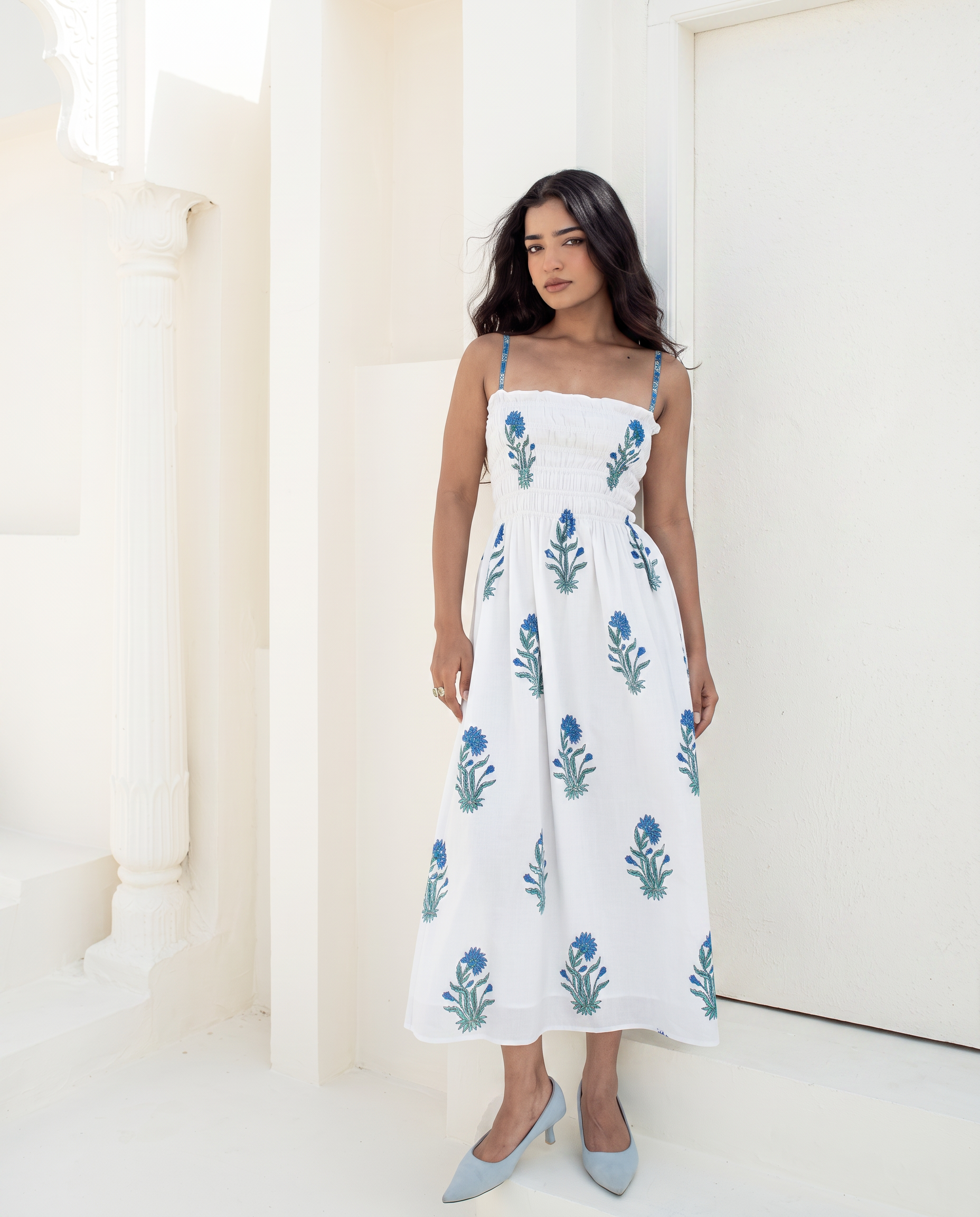 Model wearing the Blue Riviera blue floral hand block printed cotton smocked midi dress