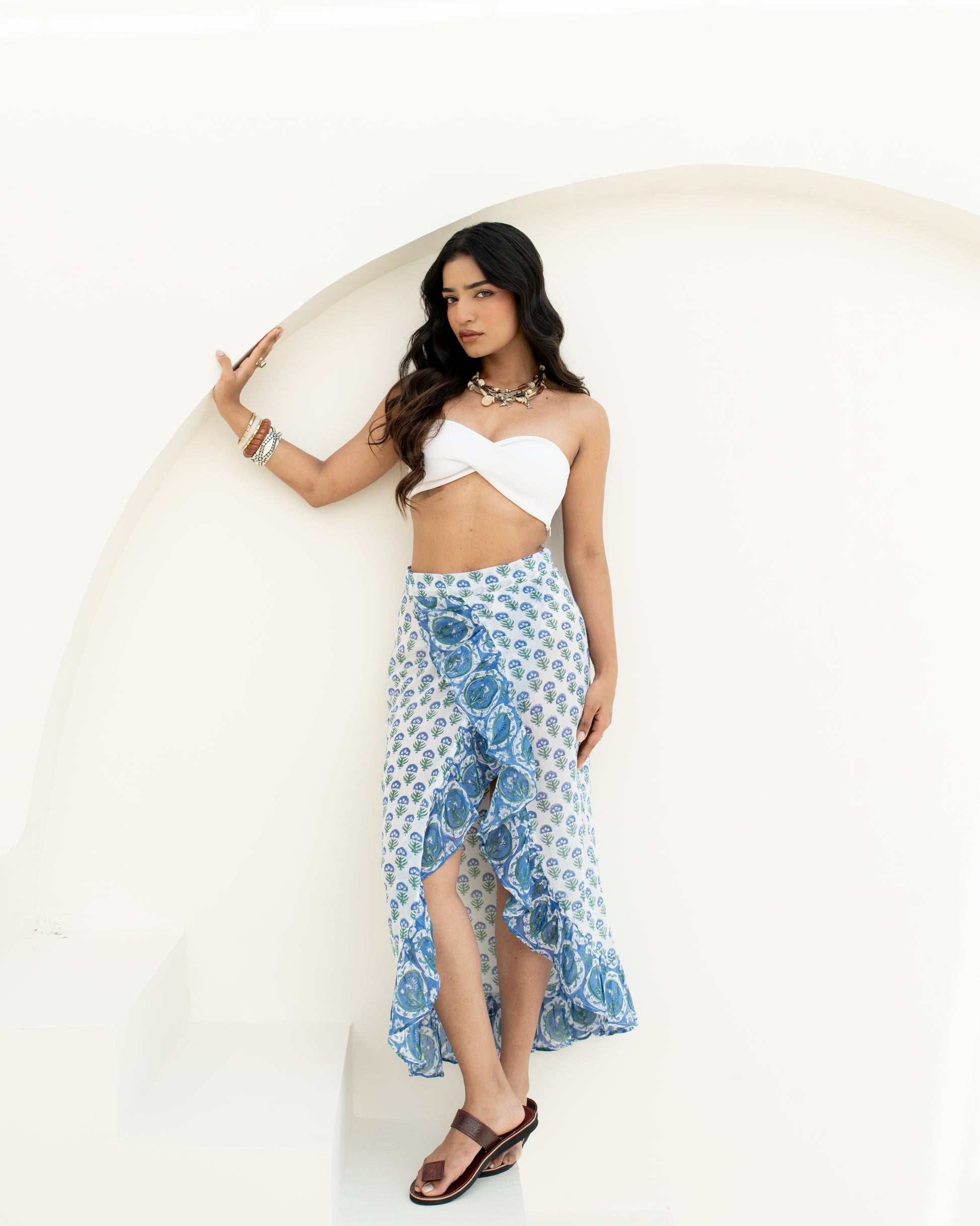 Model wearing the Blue Riviera blue and white hand block printed cotton wrap sarong for beach or resort wear