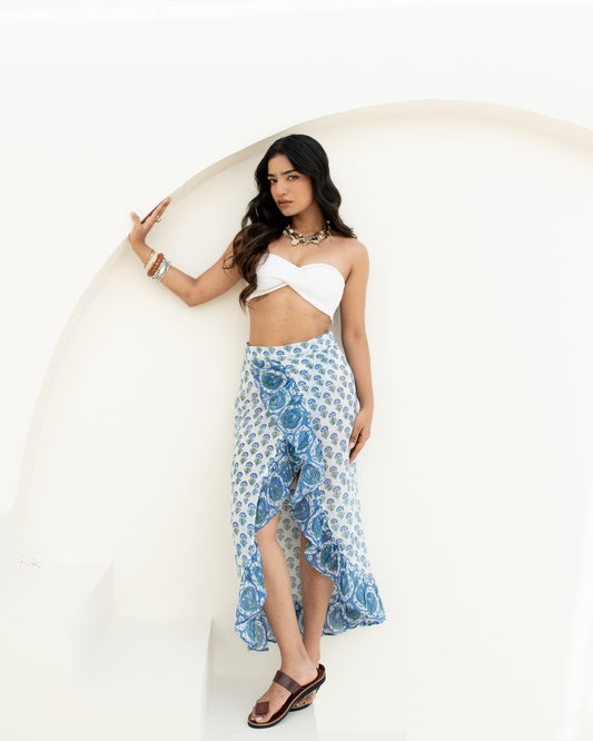 Model wearing the Blue Riviera blue and white hand block printed cotton wrap sarong for beach or resort wear
