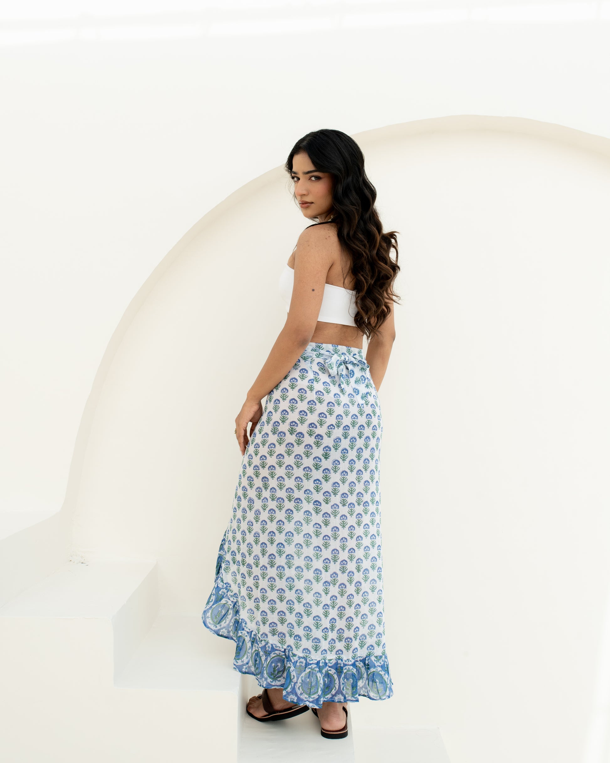 Model wearing the Blue Riviera blue and white hand block printed cotton wrap sarong with tie and ruffle details