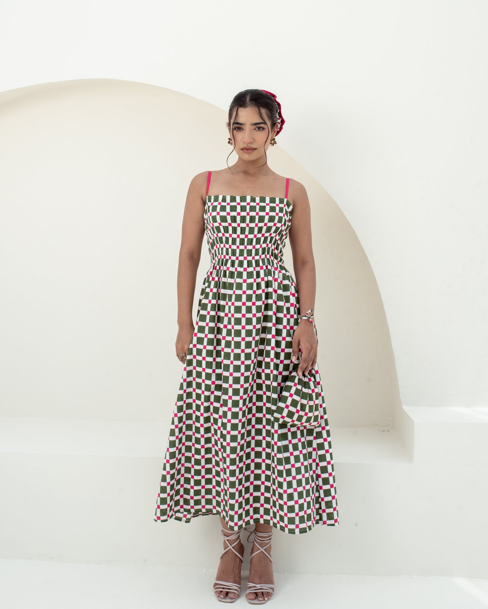 Model wearing the Garden Checks green and pink screen printed smocked midi dress