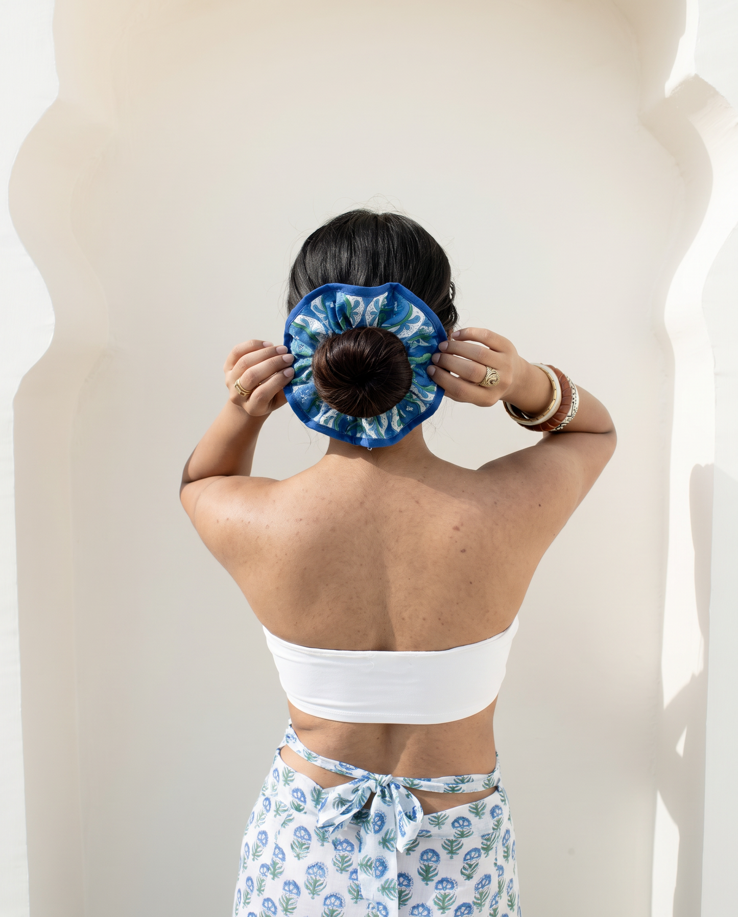 Model wearing Blue Riviera floral scrunchie around hair bun made with hand block printed cotton